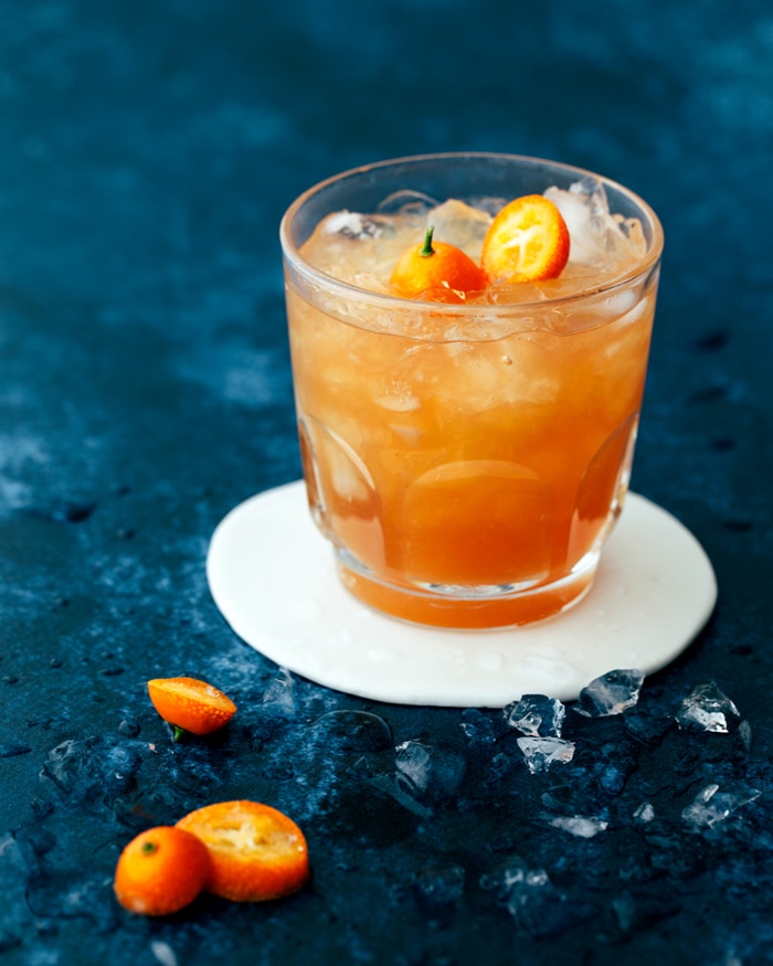 mocktail with a kumquat garnish