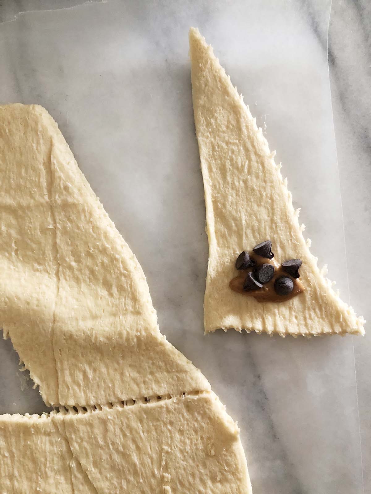 crescent roll triangle with peanut butter and chocolate chips