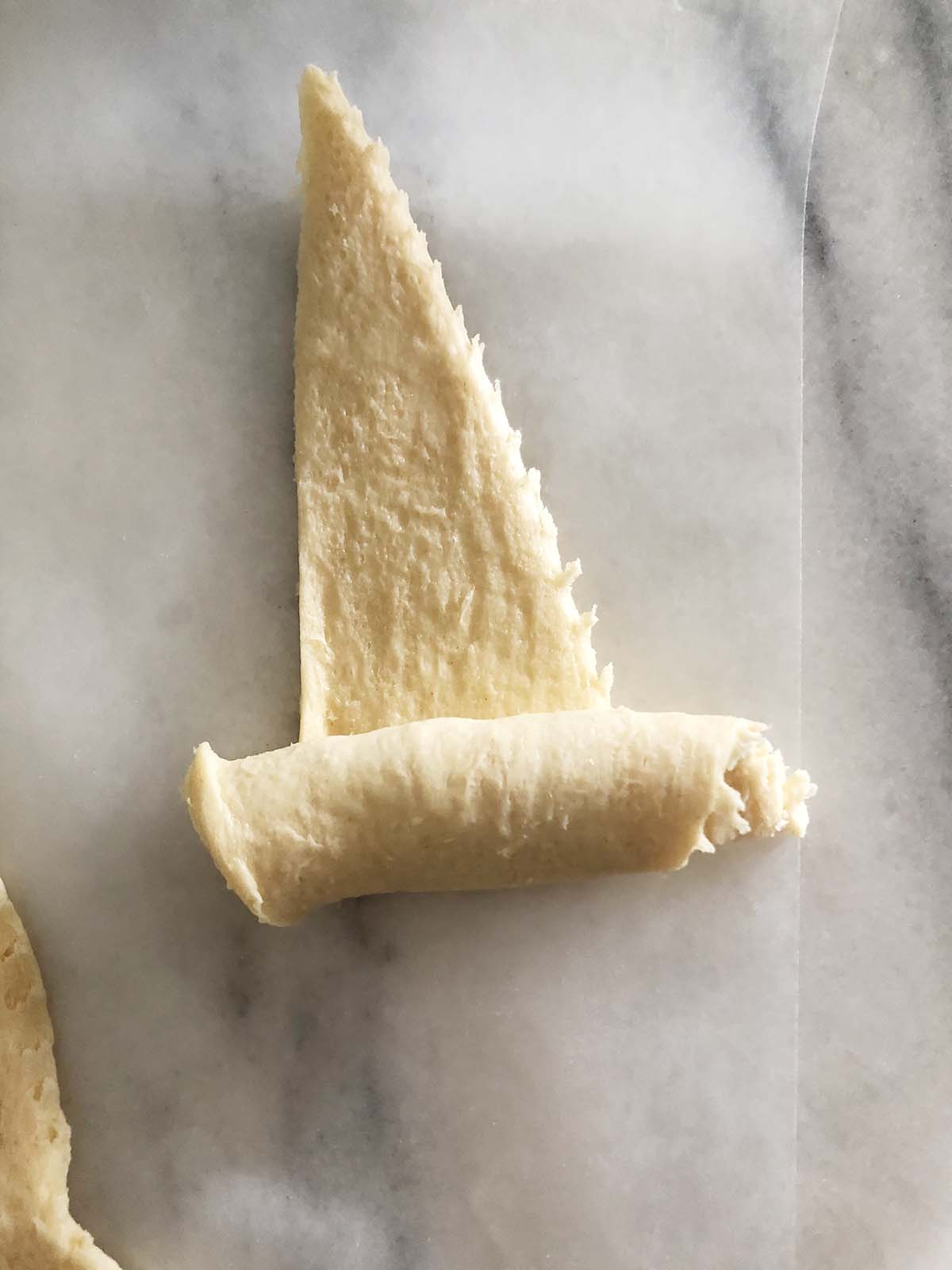 crescent roll being rolled