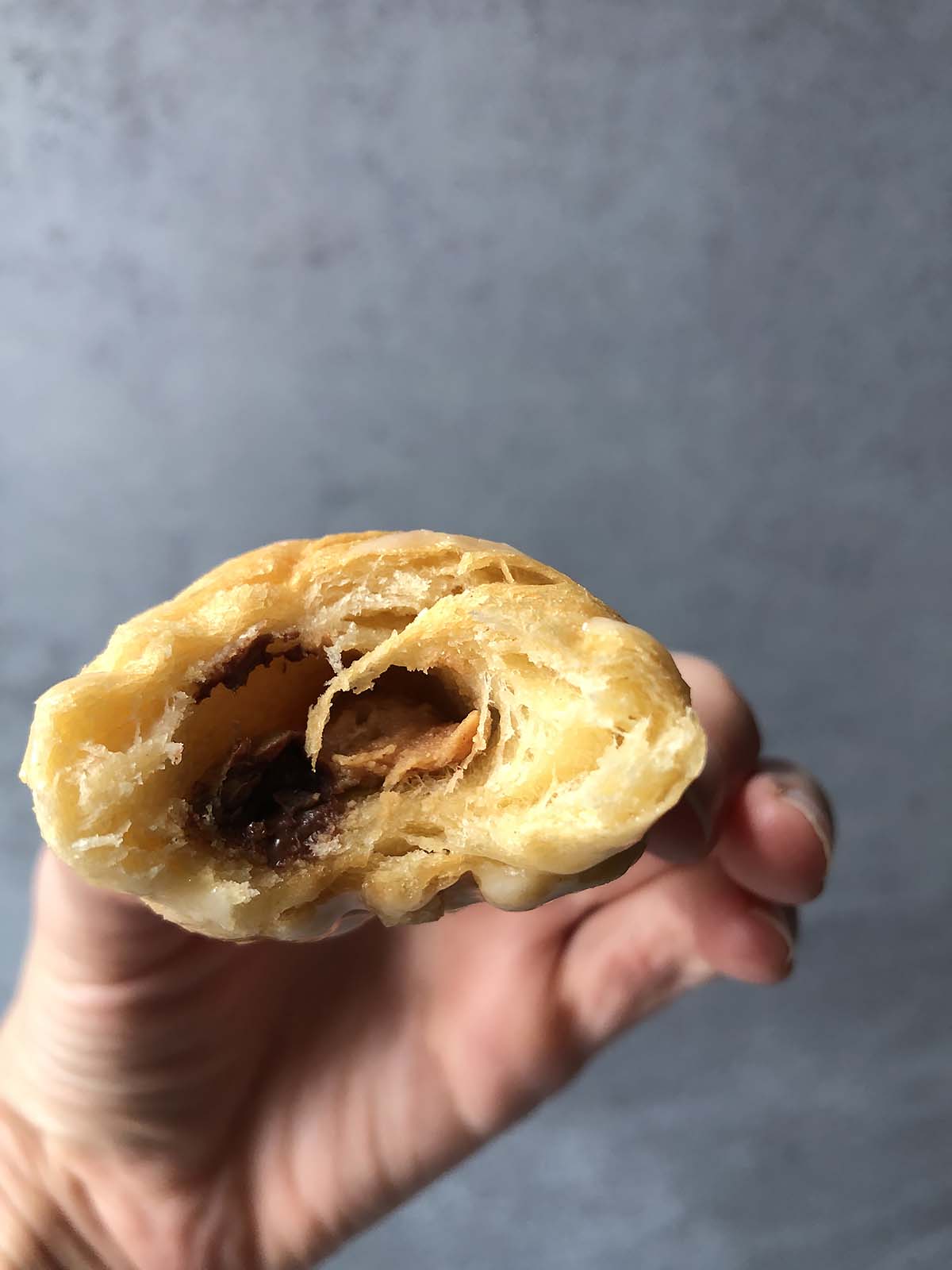 a half-eaten peanut butter chocolate croissant