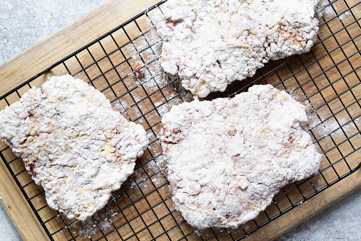 breaded steak resting on a rack