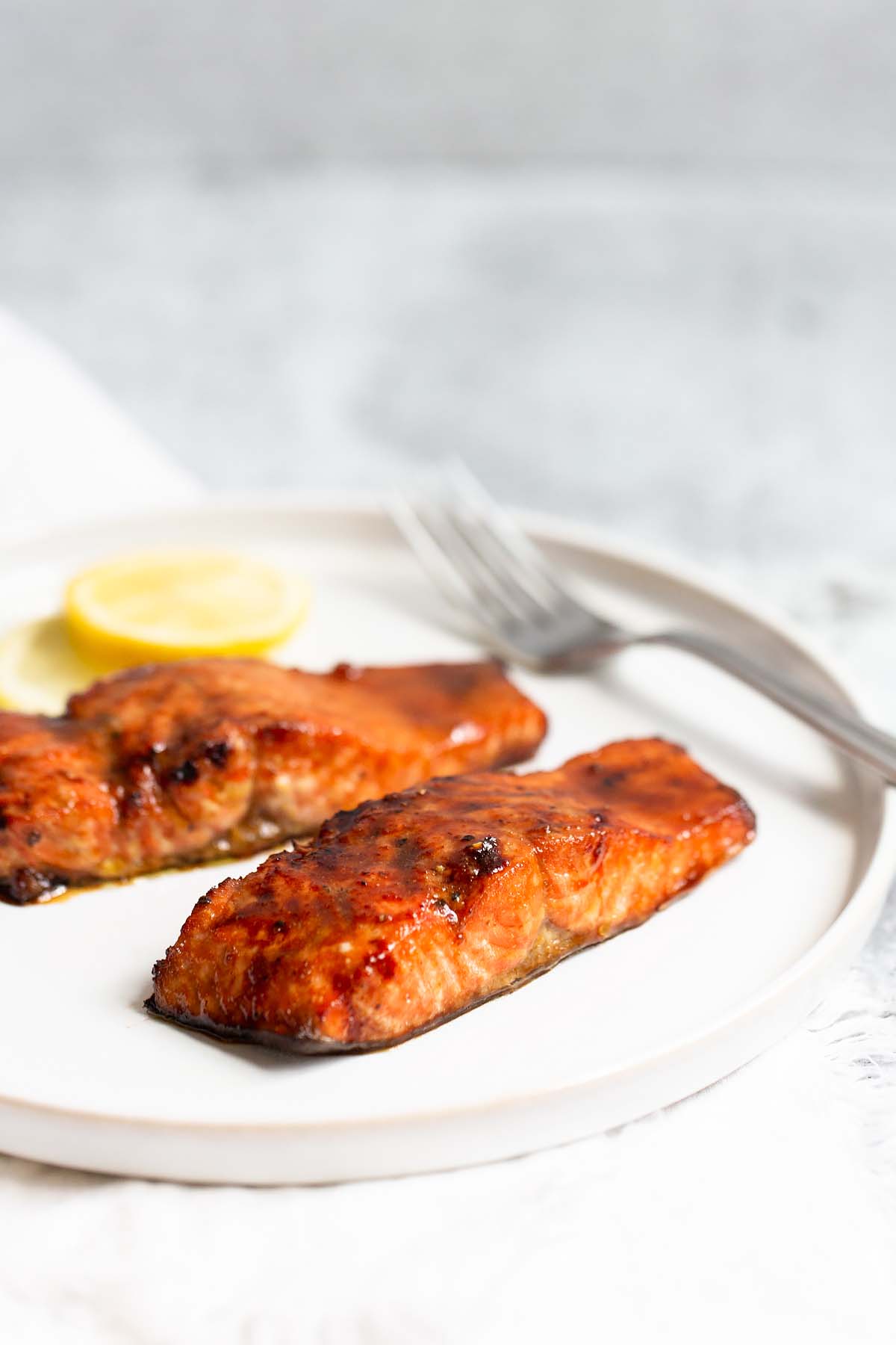 Two pieces of cooked salmon from the side.