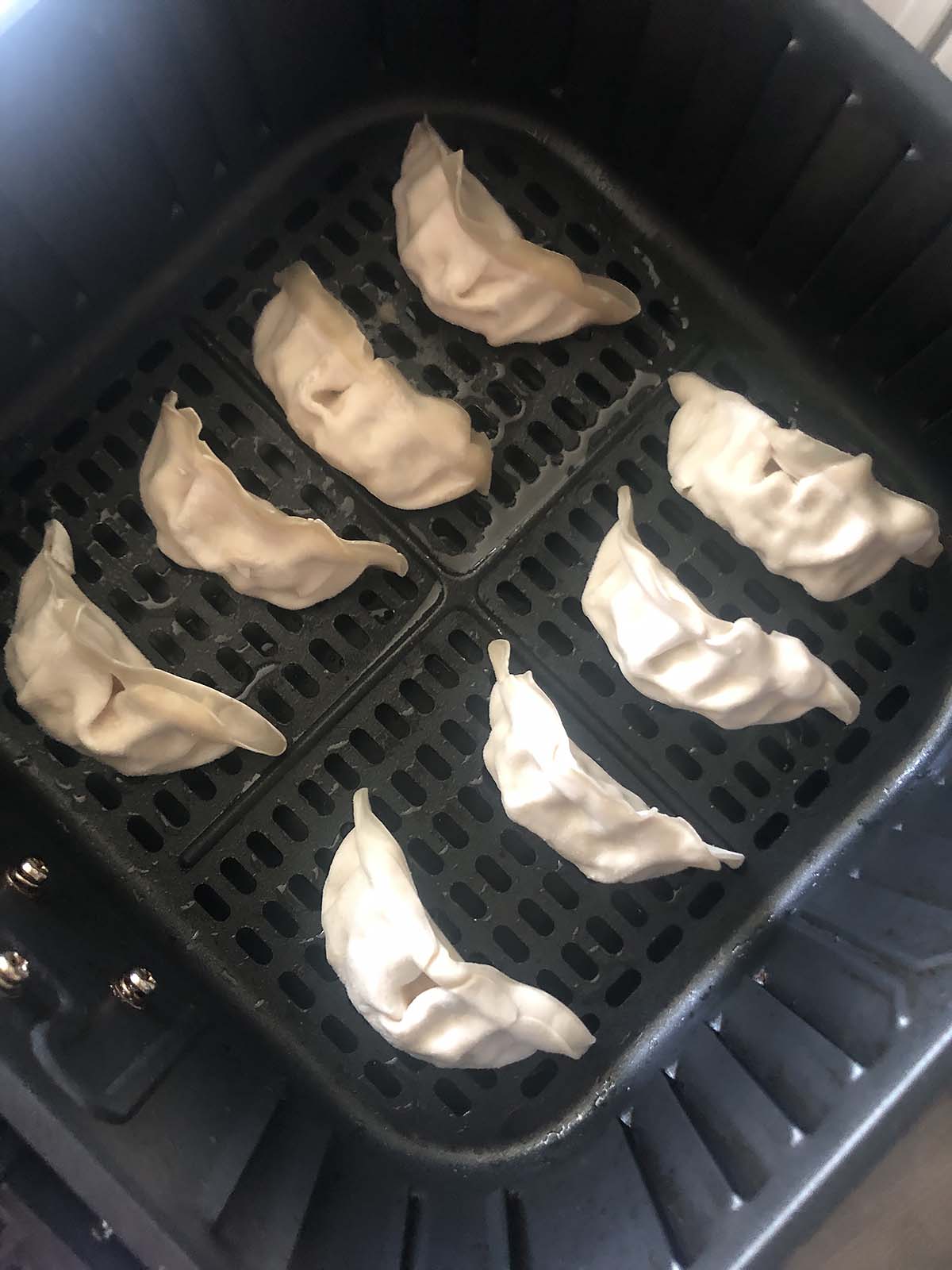 uncooked potstickers in air fryer basket