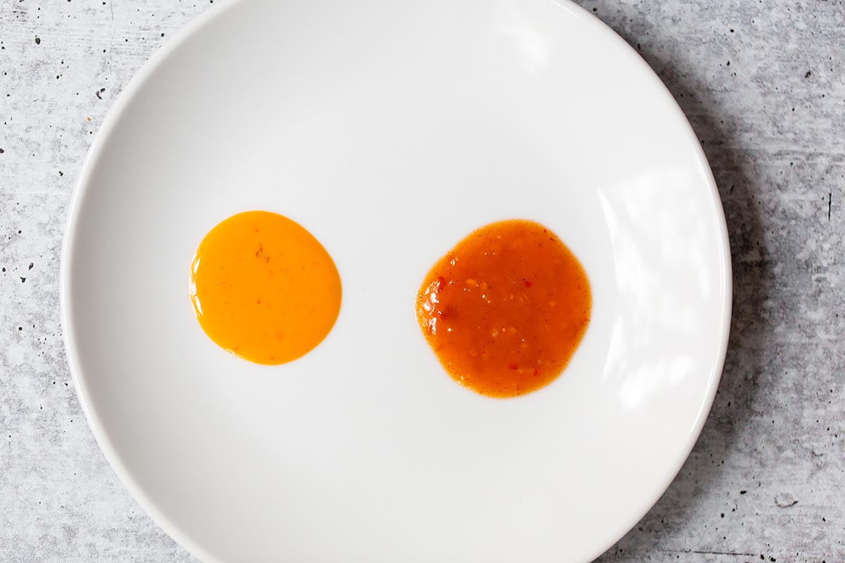 two dollops of peri peri sauce on a white plate