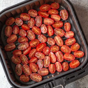 raw tomatoes in air fryer basket