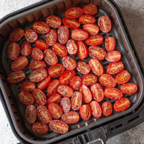 raw tomatoes in air fryer basket