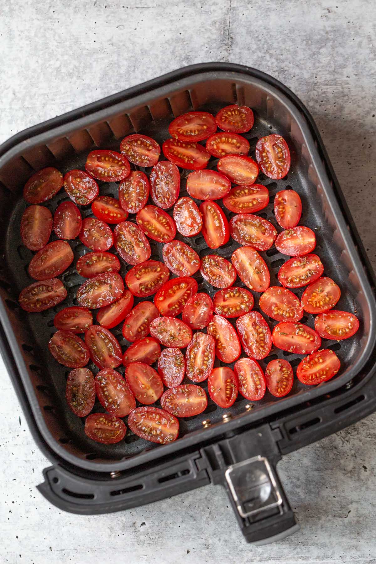 raw tomatoes in air fryer basket