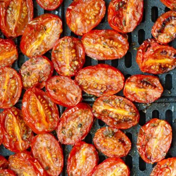 Tomatoes in air fryer basket.