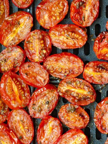 Tomatoes in air fryer basket.