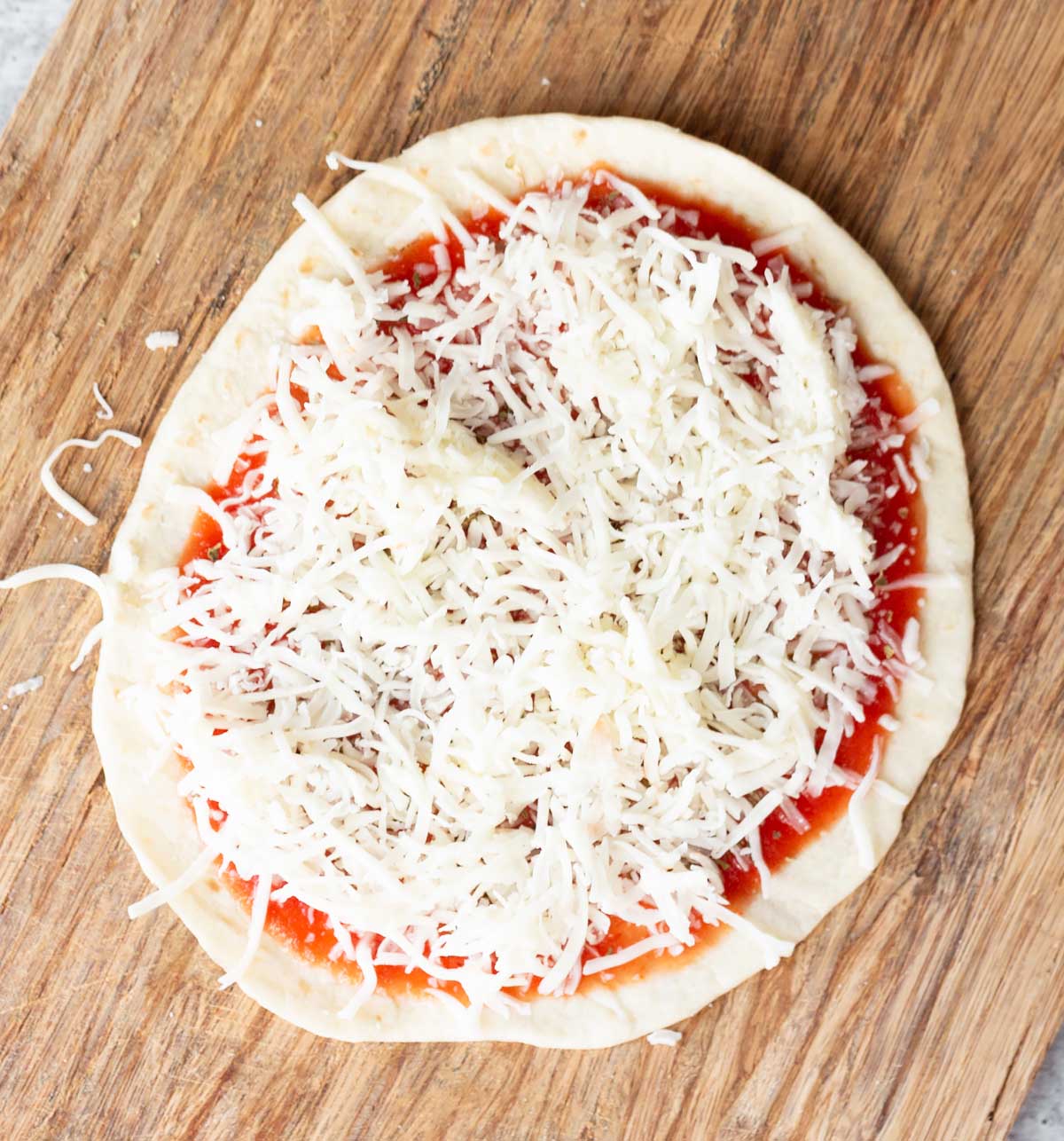 tortilla topped with tomato sauce and cheese