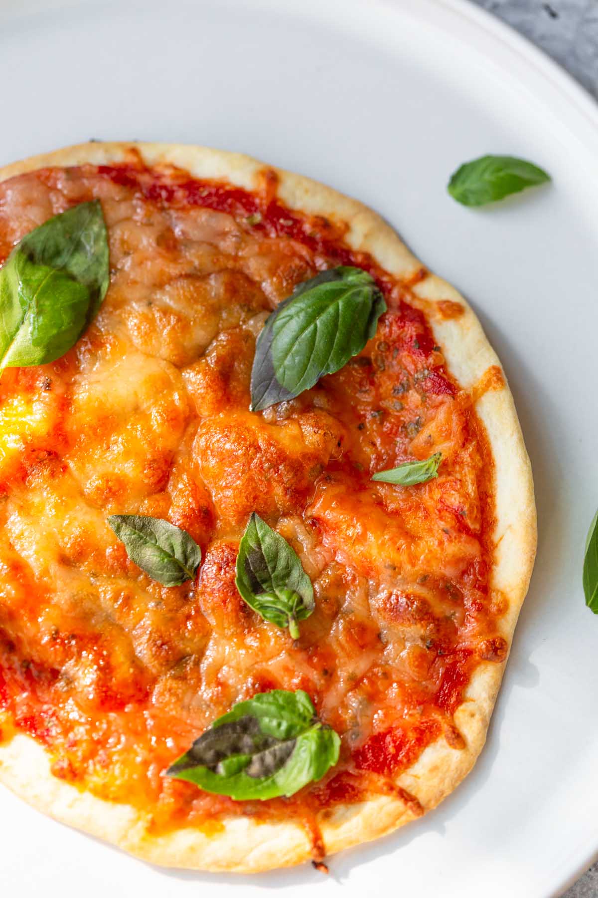 air fryer tortilla pizza topped with fresh basil