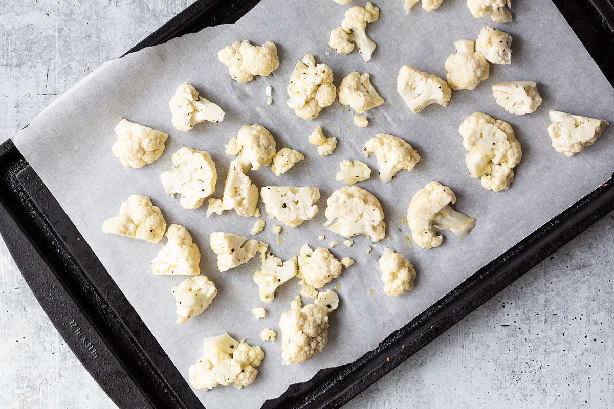 uncooked cauliflower florets on baking sheet