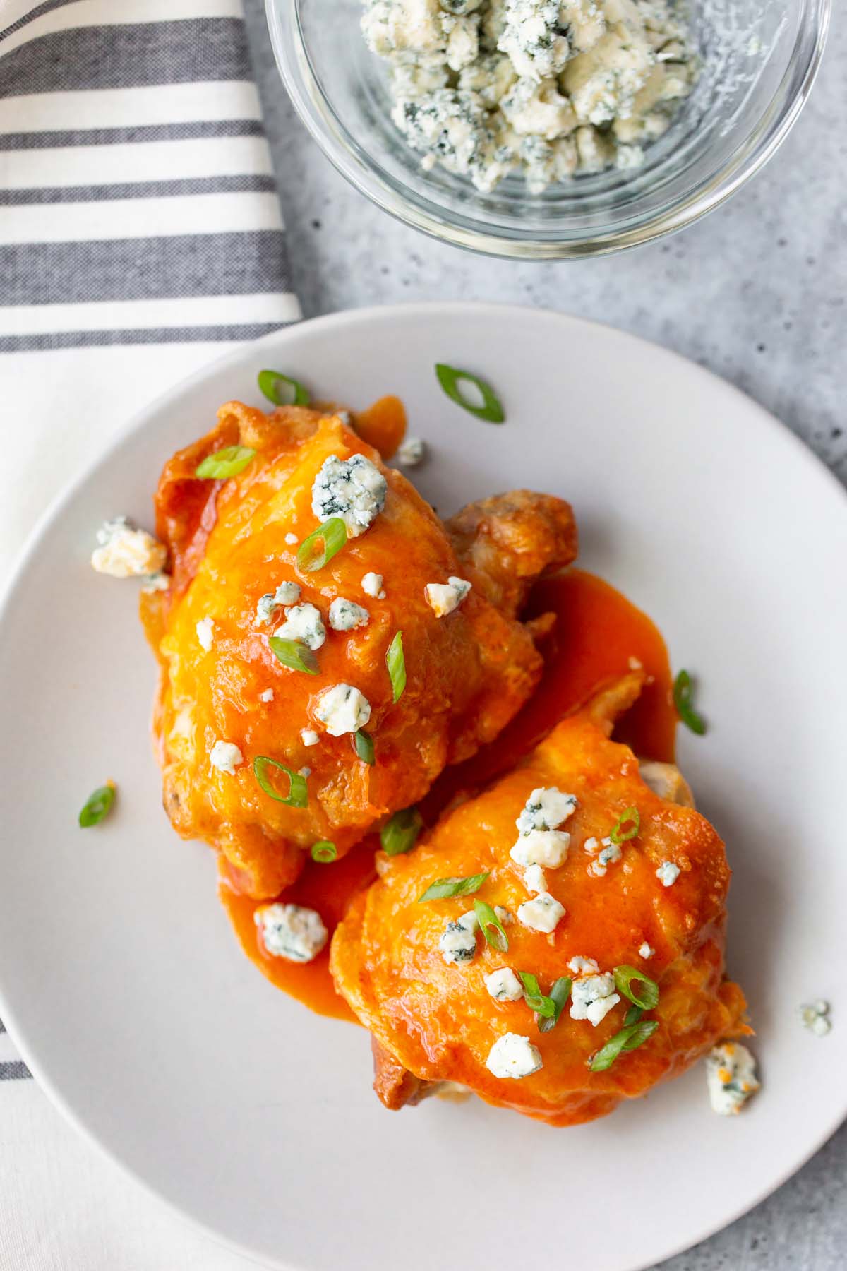 buffalo chicken thighs topped with blue cheese and green onions