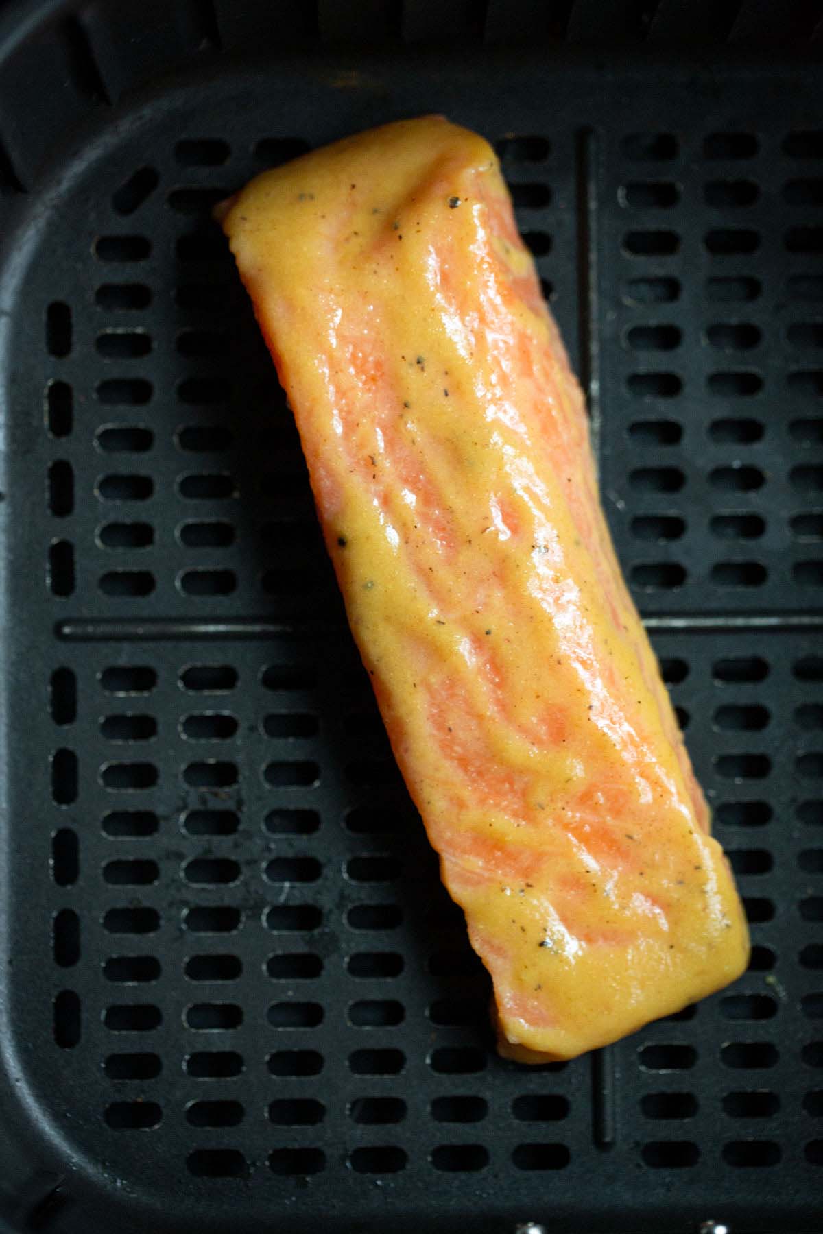 Uncooked salmon in air fryer.