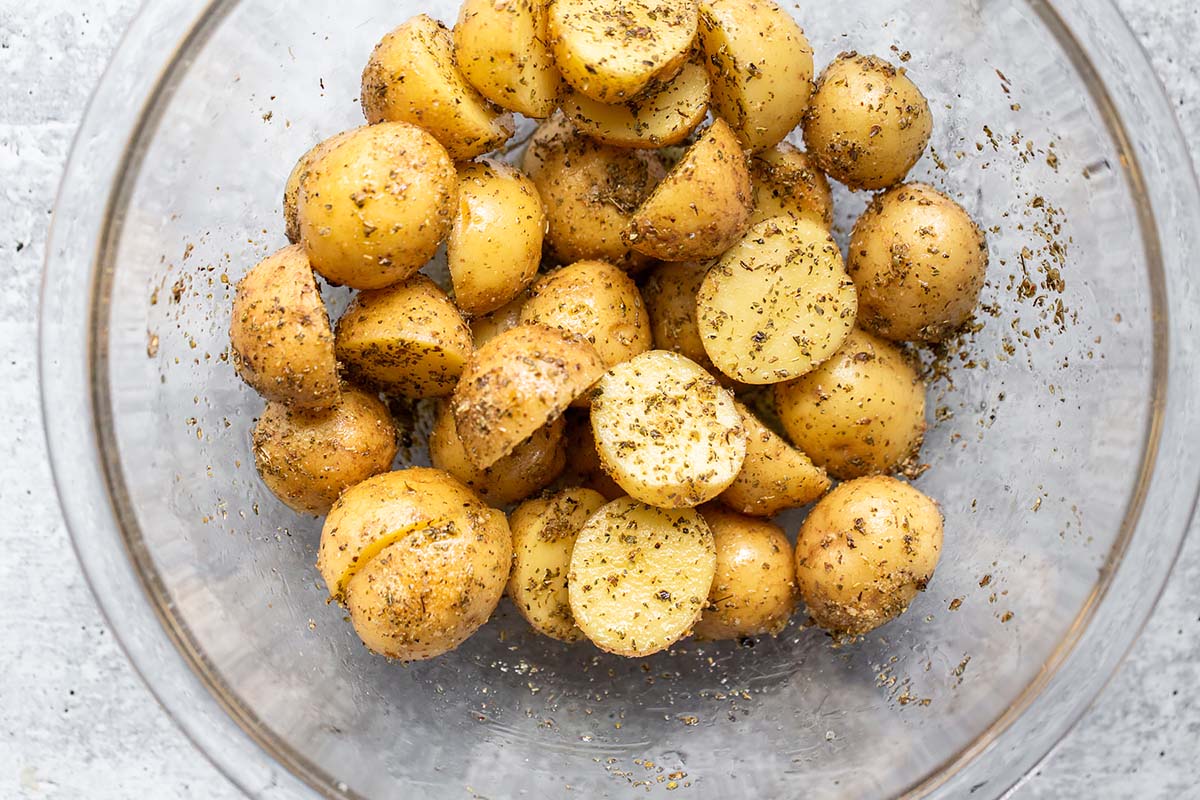potatoes in a glass bowl with seasonings