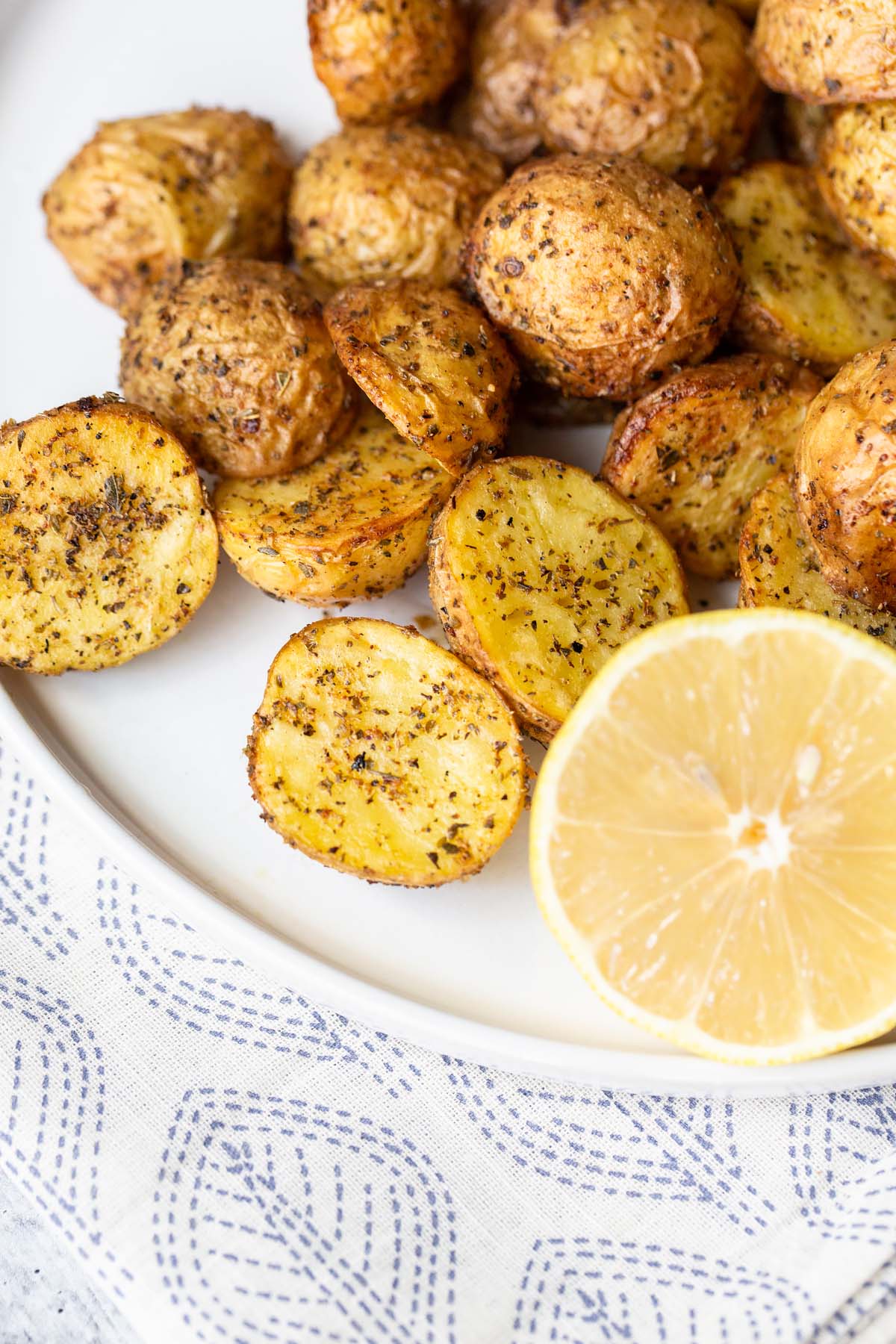 potatoes with a lemon on a white plate