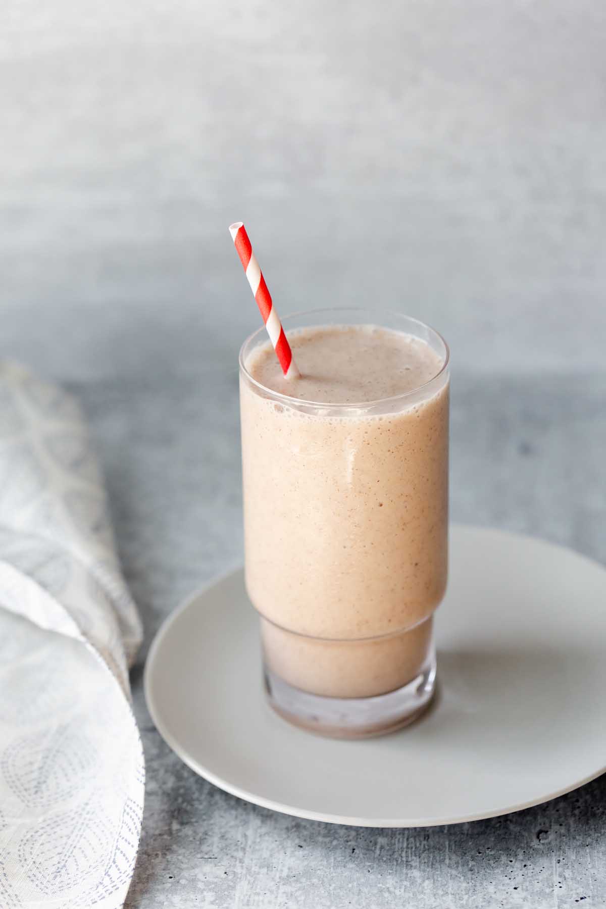 smoothie with a red and white striped straw