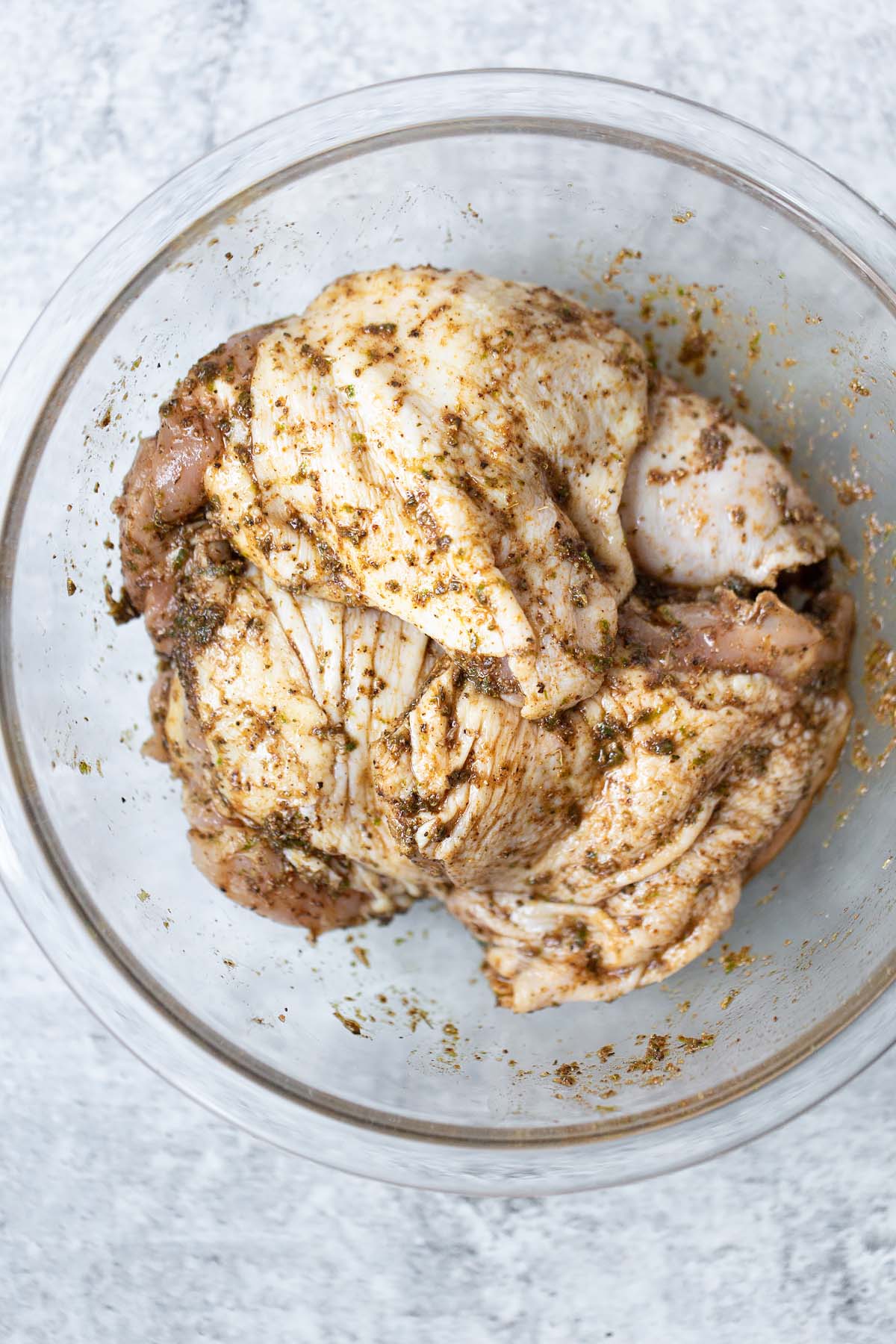 chicken thighs marinating in a bowl