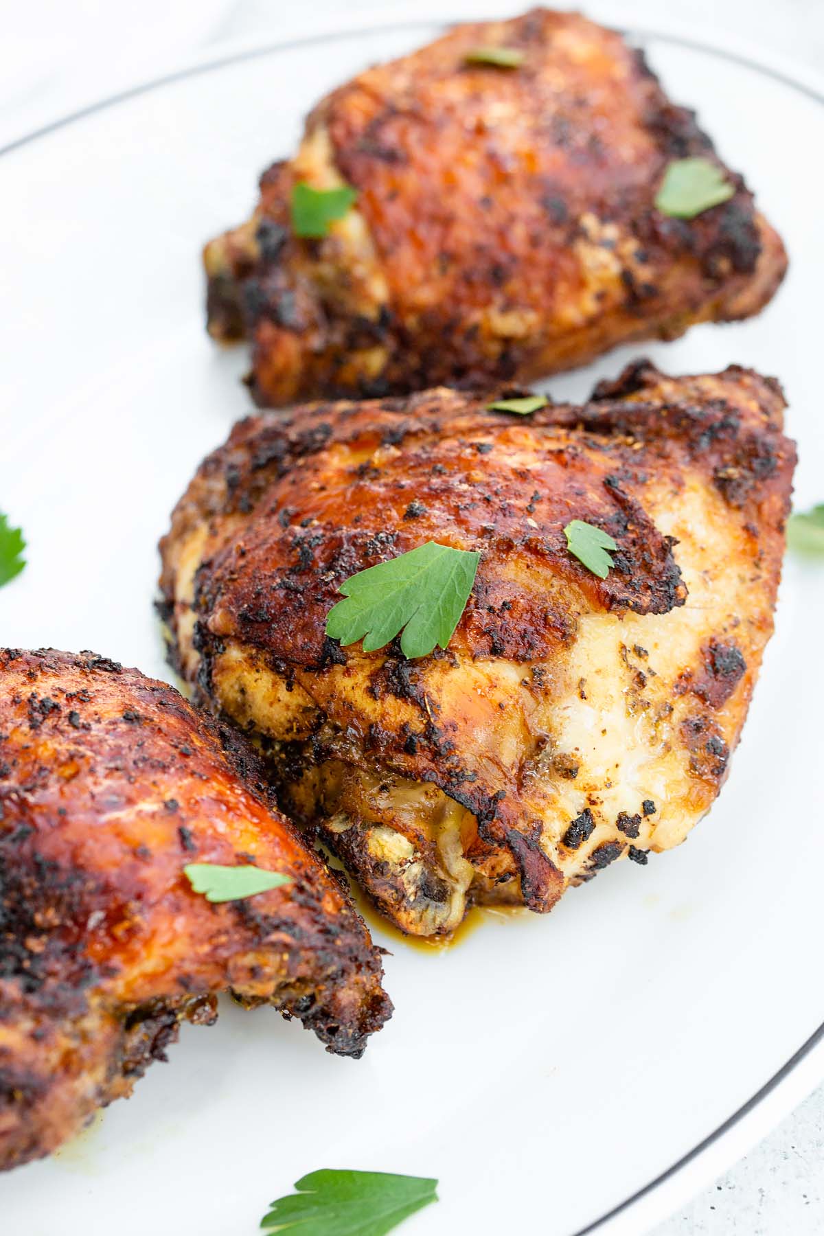 chili lime chicken thighs up close with parsley leaves