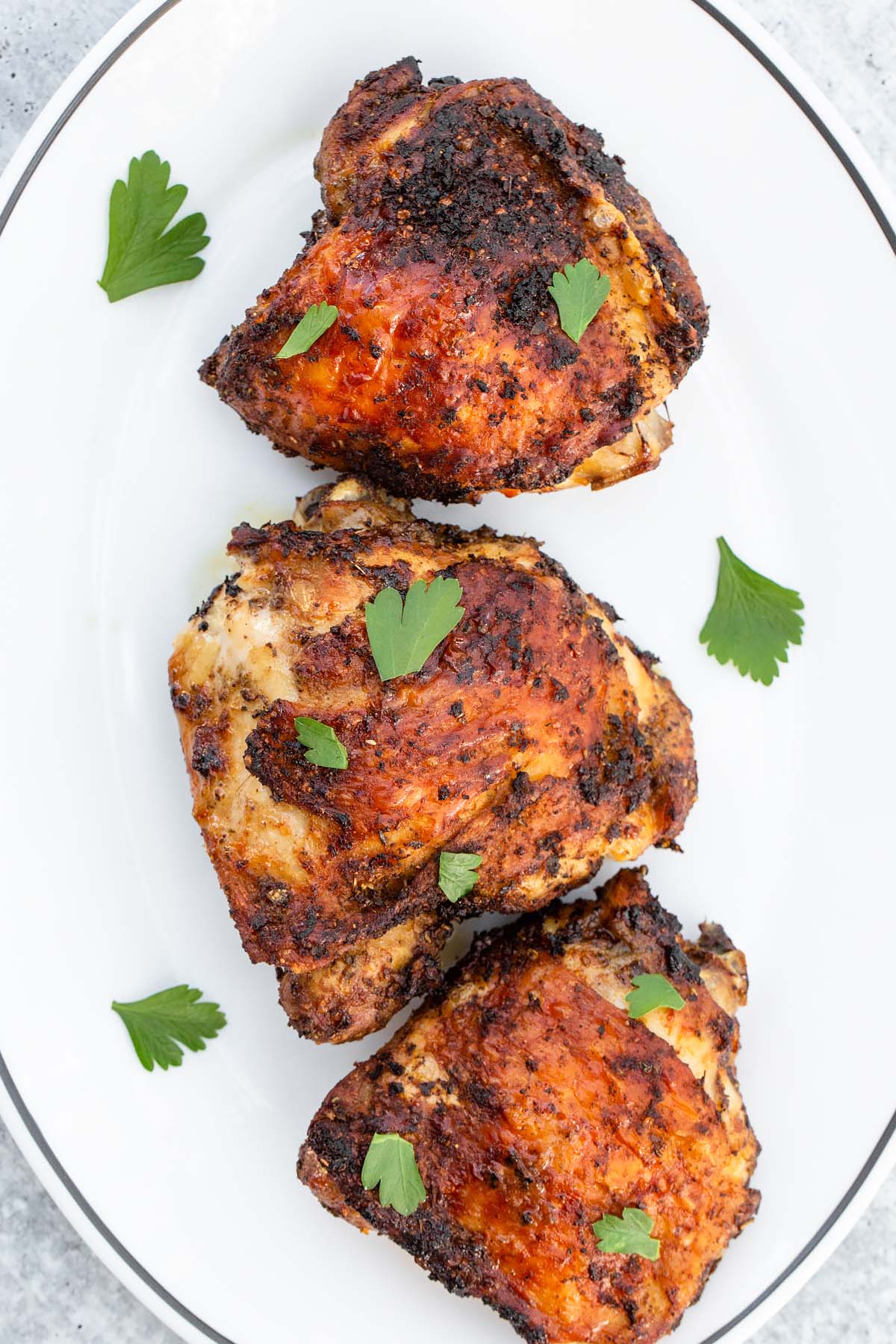 chicken thighs on a plate with parsley