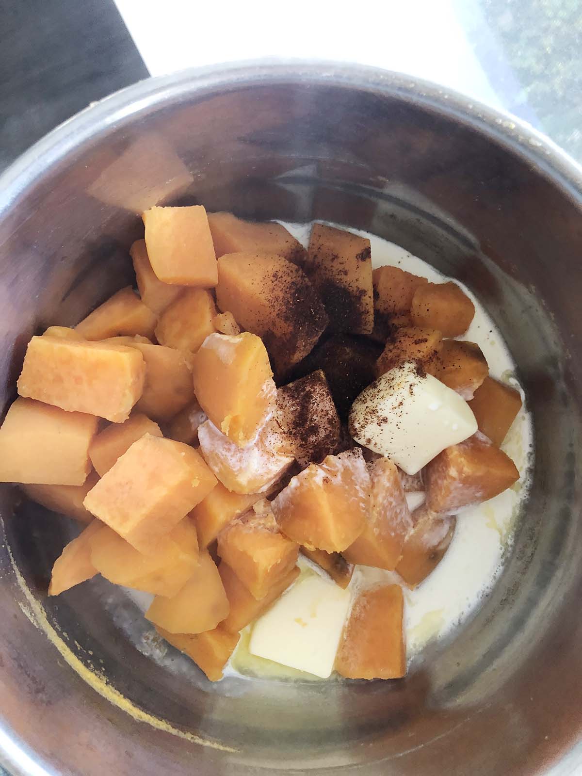 sweet potatoes, butter, cream, and chipotle powder in a pot