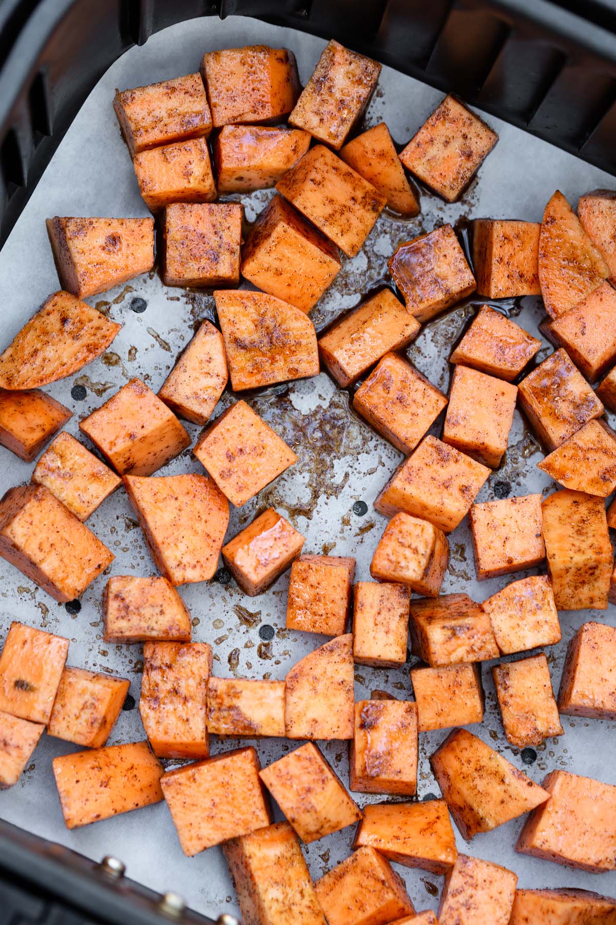 uncooked sweet potatoes in air fryer basket