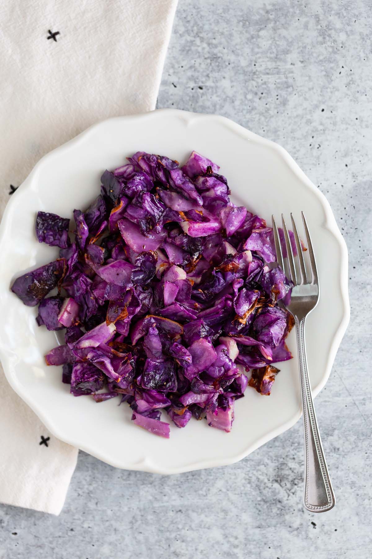 roasted red cabbage on a plate with a fork