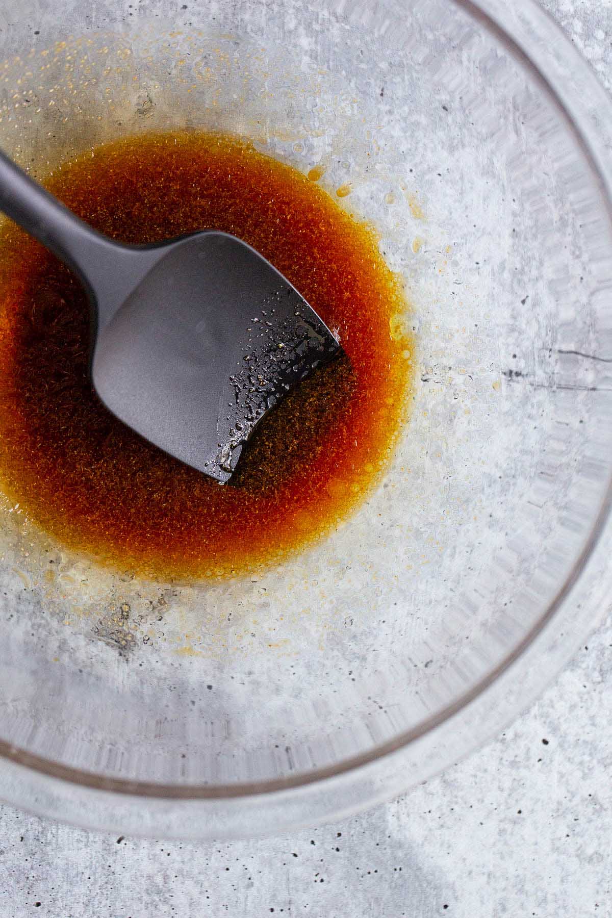 marinade in a bowl with a black spatula