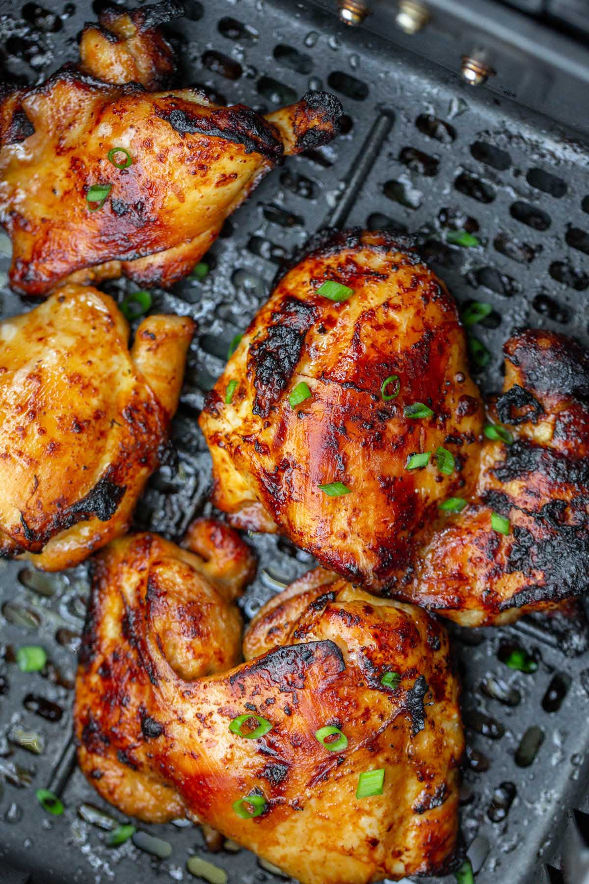 cooked chicken thighs in air fryer basket