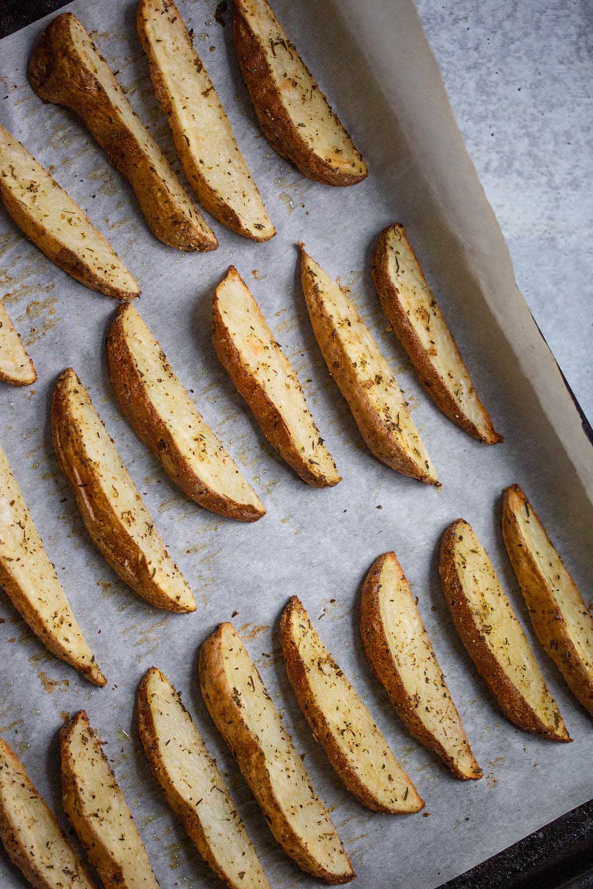 cooked fries on a baking sheet.