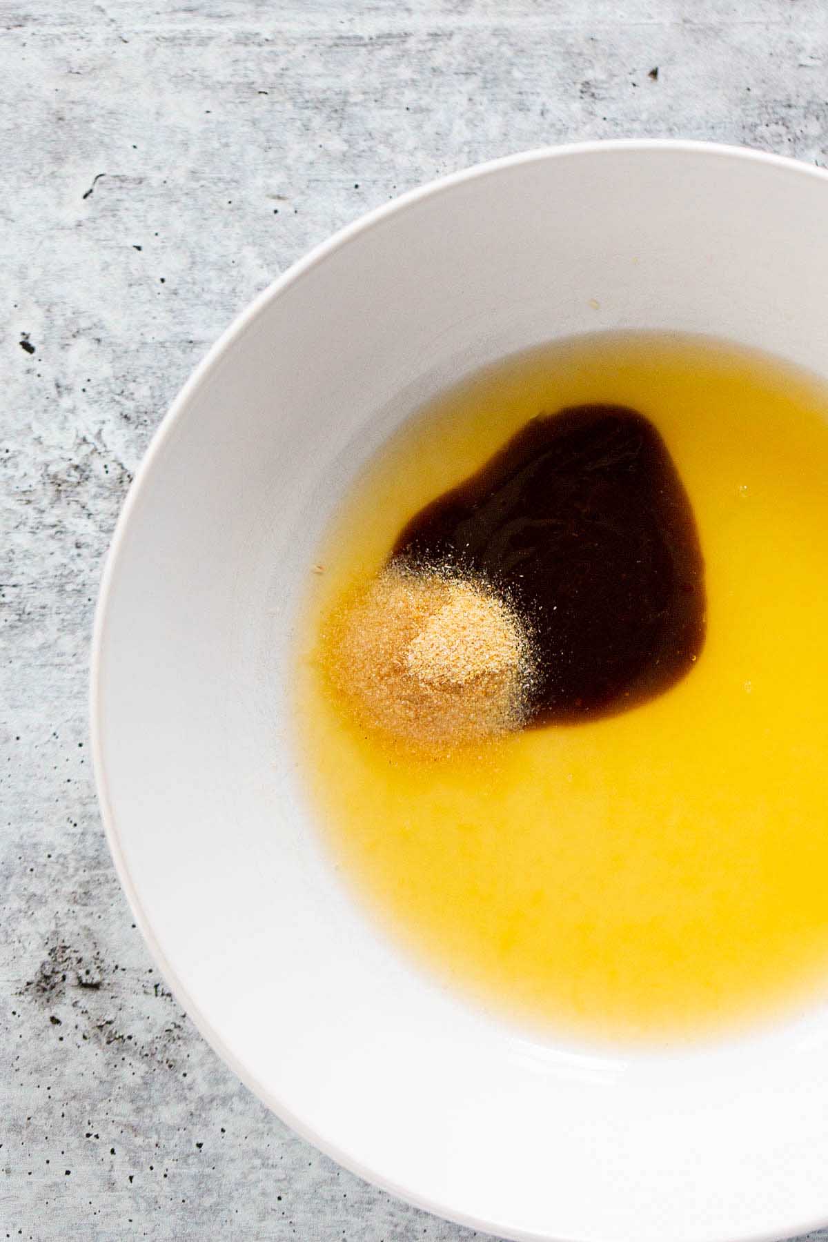 making the marinade. Olive oil, orange juice, hoisin, and garlic powder in a bowl