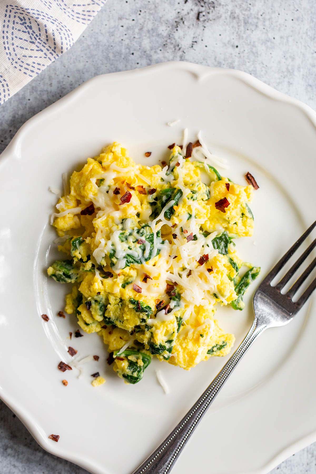 spinach and eggs with a fork