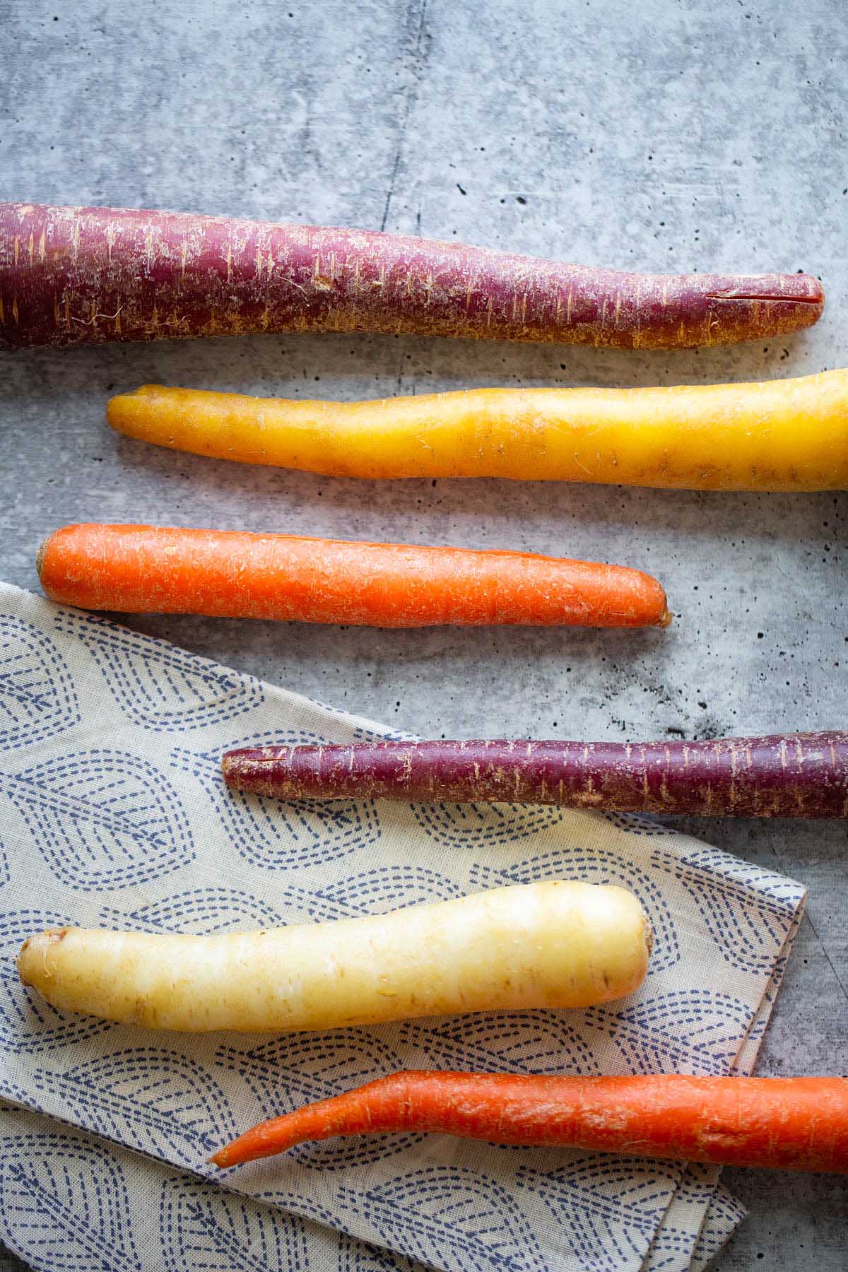 5 unpeeled rainbow carrots.