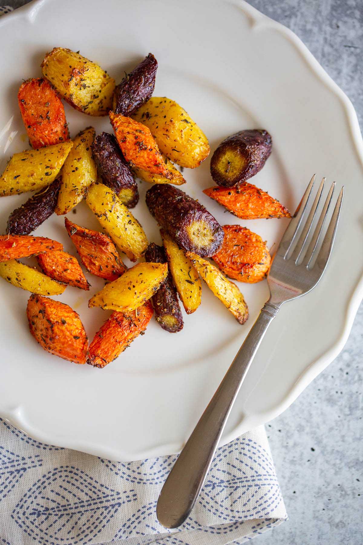 Cooked rainbow carrots on a plate.