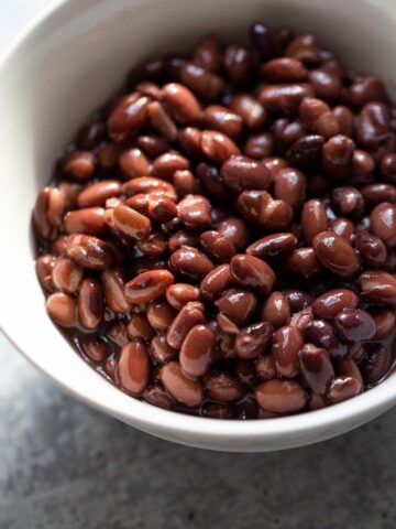 Black beans in a white bowl.