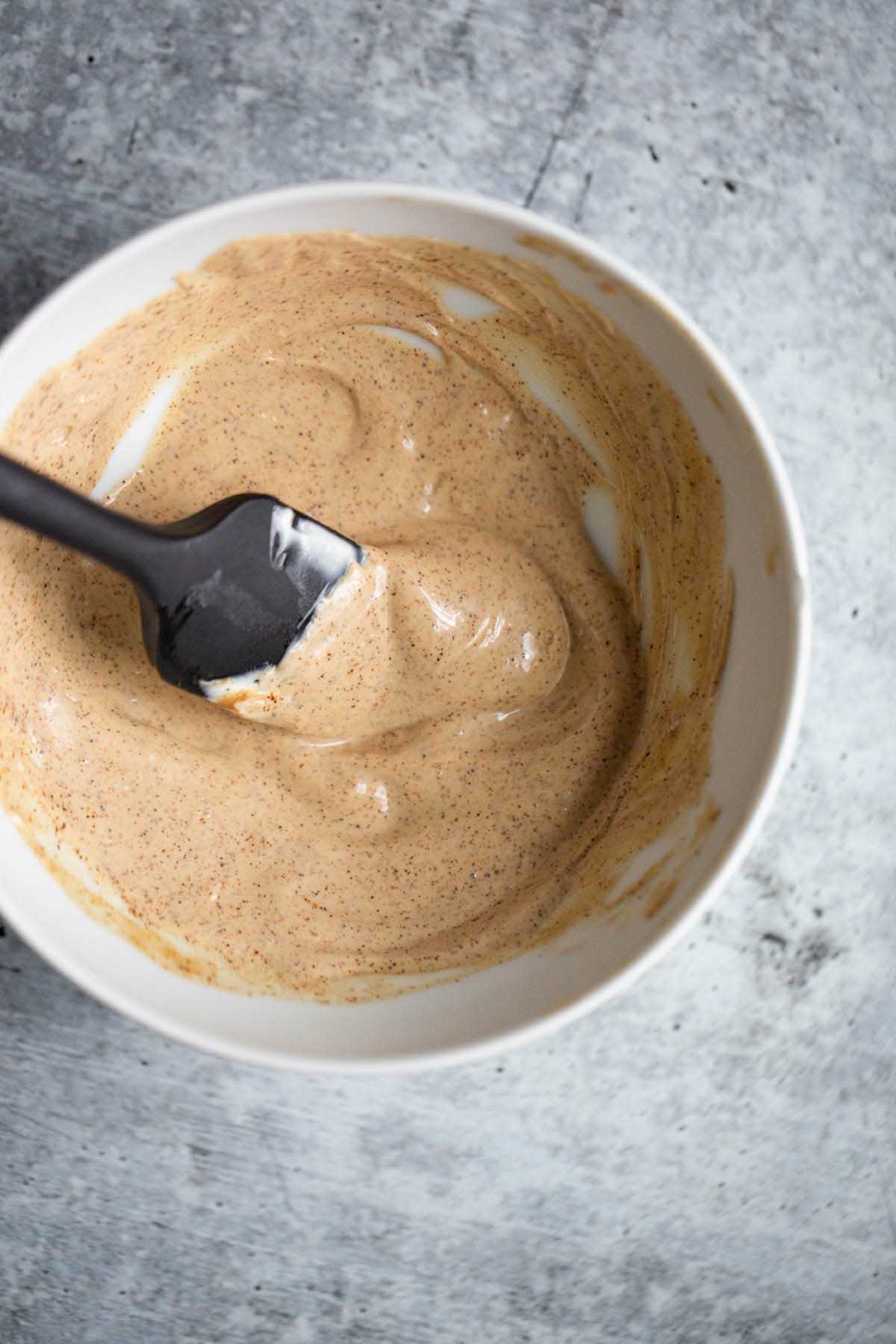 mayo in a bowl with a black spatula.