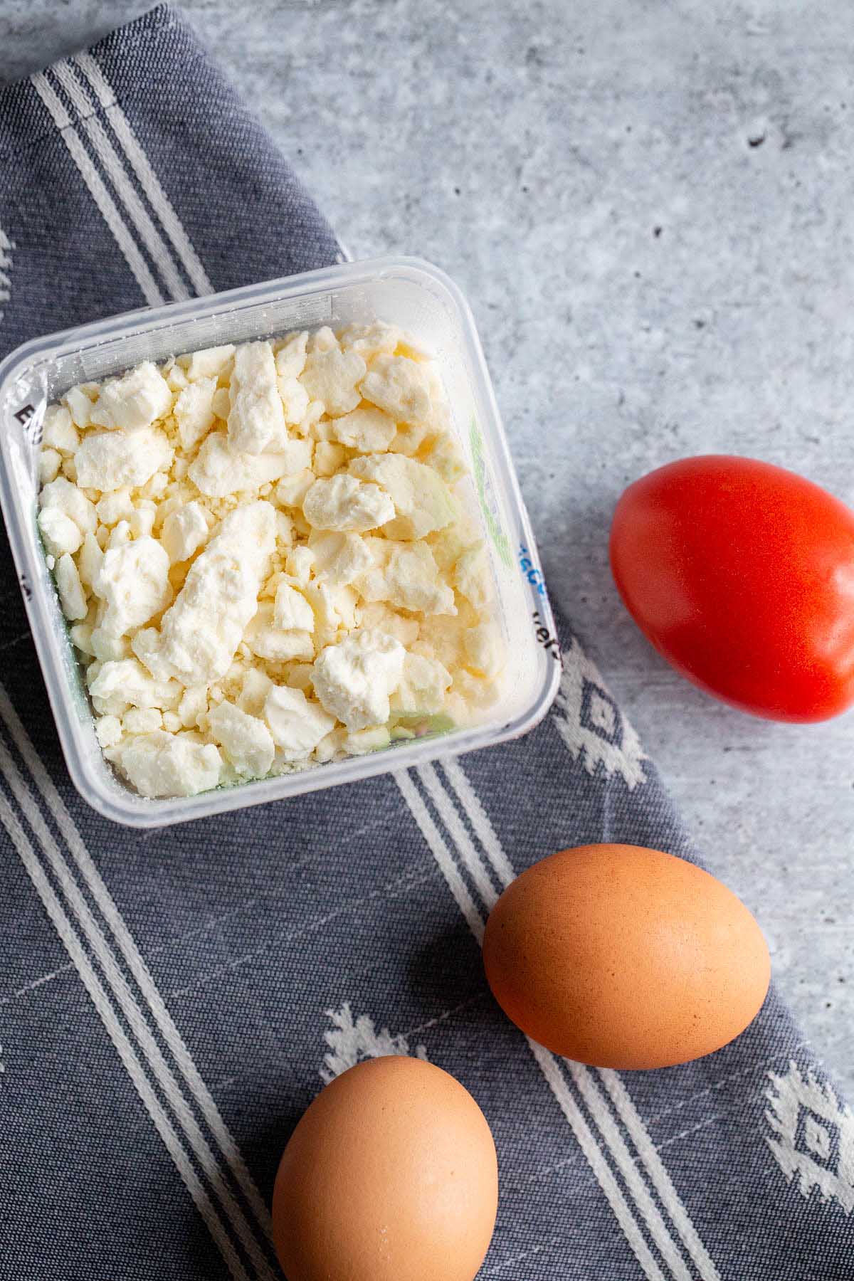 Feta, a tomato, and two eggs.