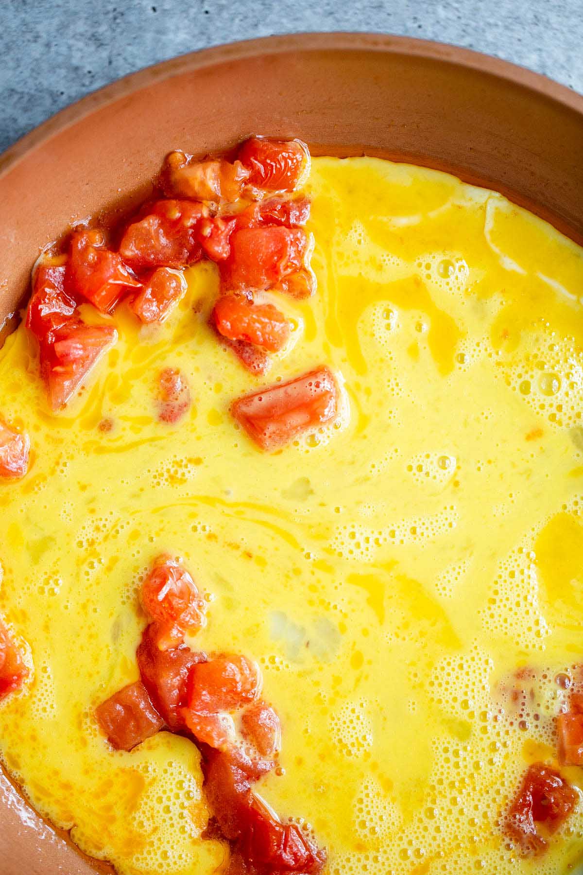 Cooking eggs with tomatoes.