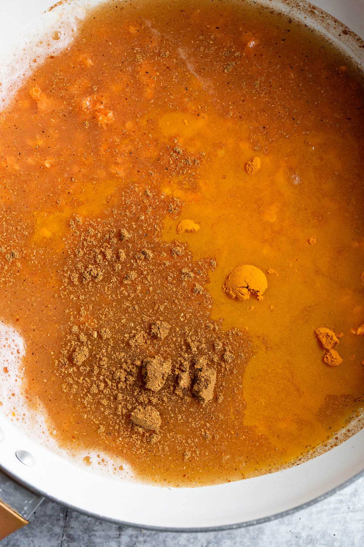 Adding spices to lentils.