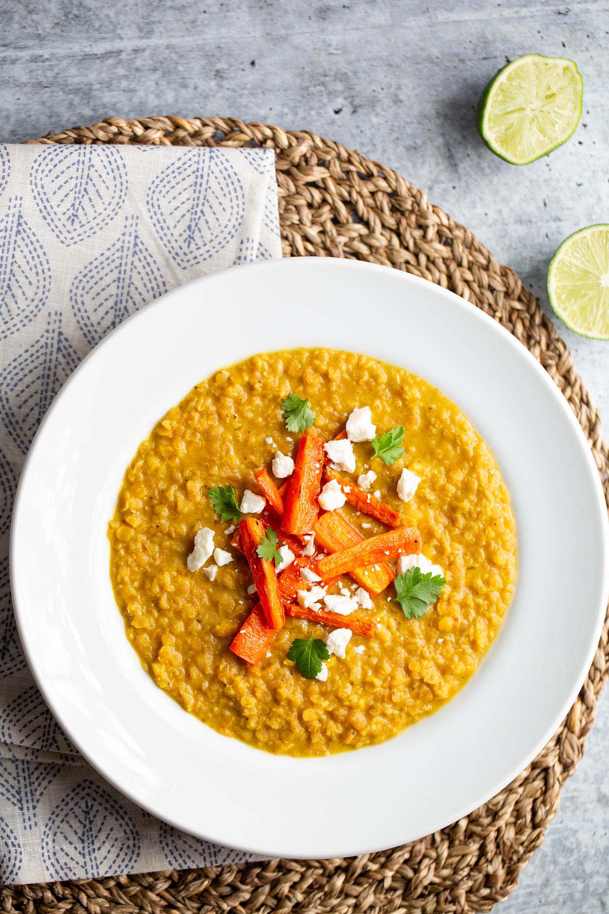 Red lentil dal topped with carrots, cilantro, and feta.