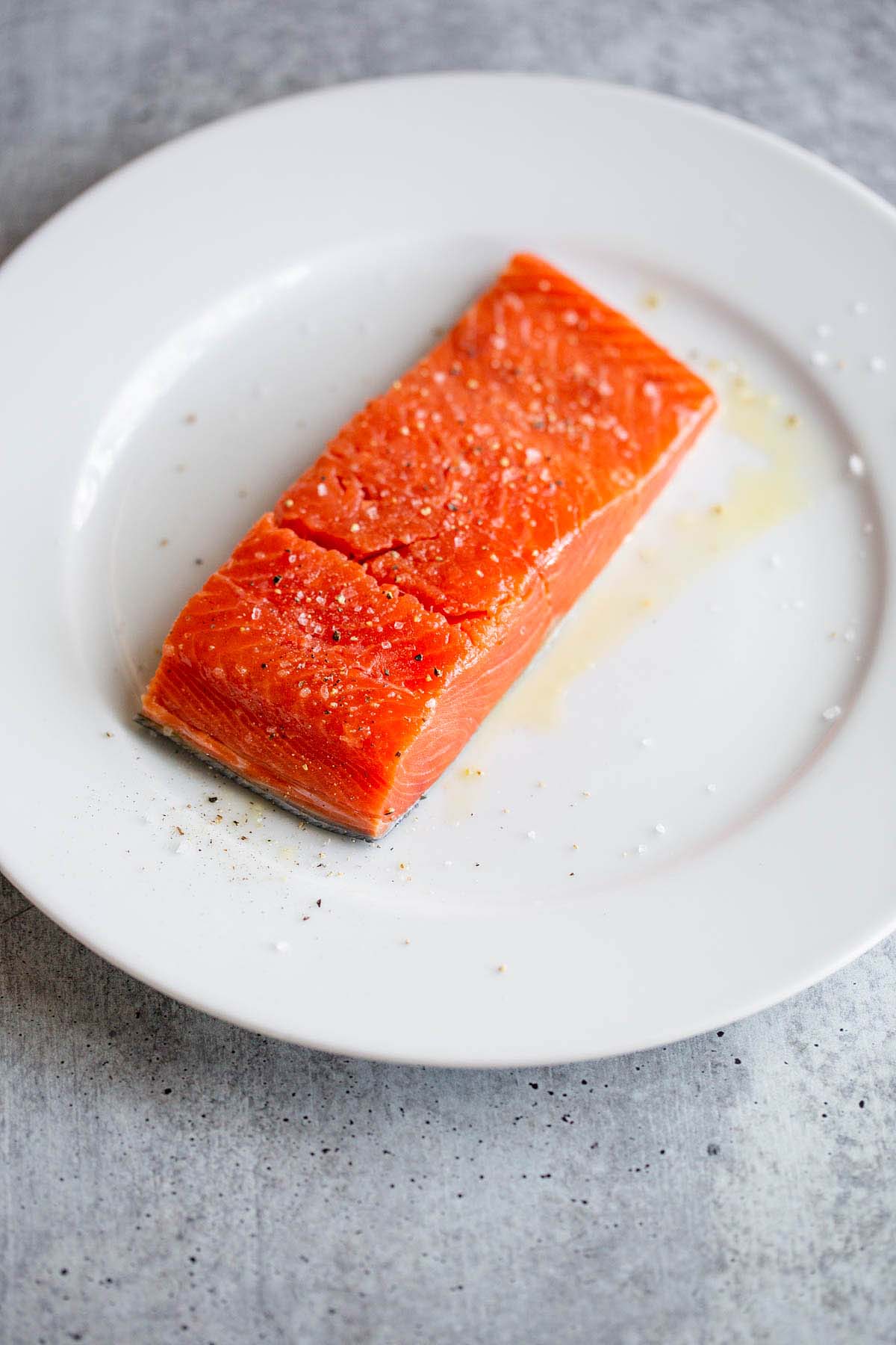 Raw salmon on a white plate.