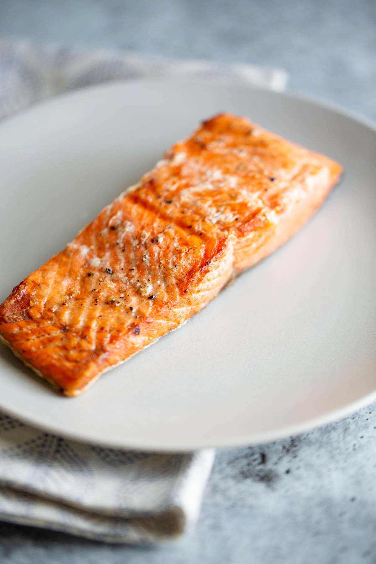 Air fried salmon on a white plate.