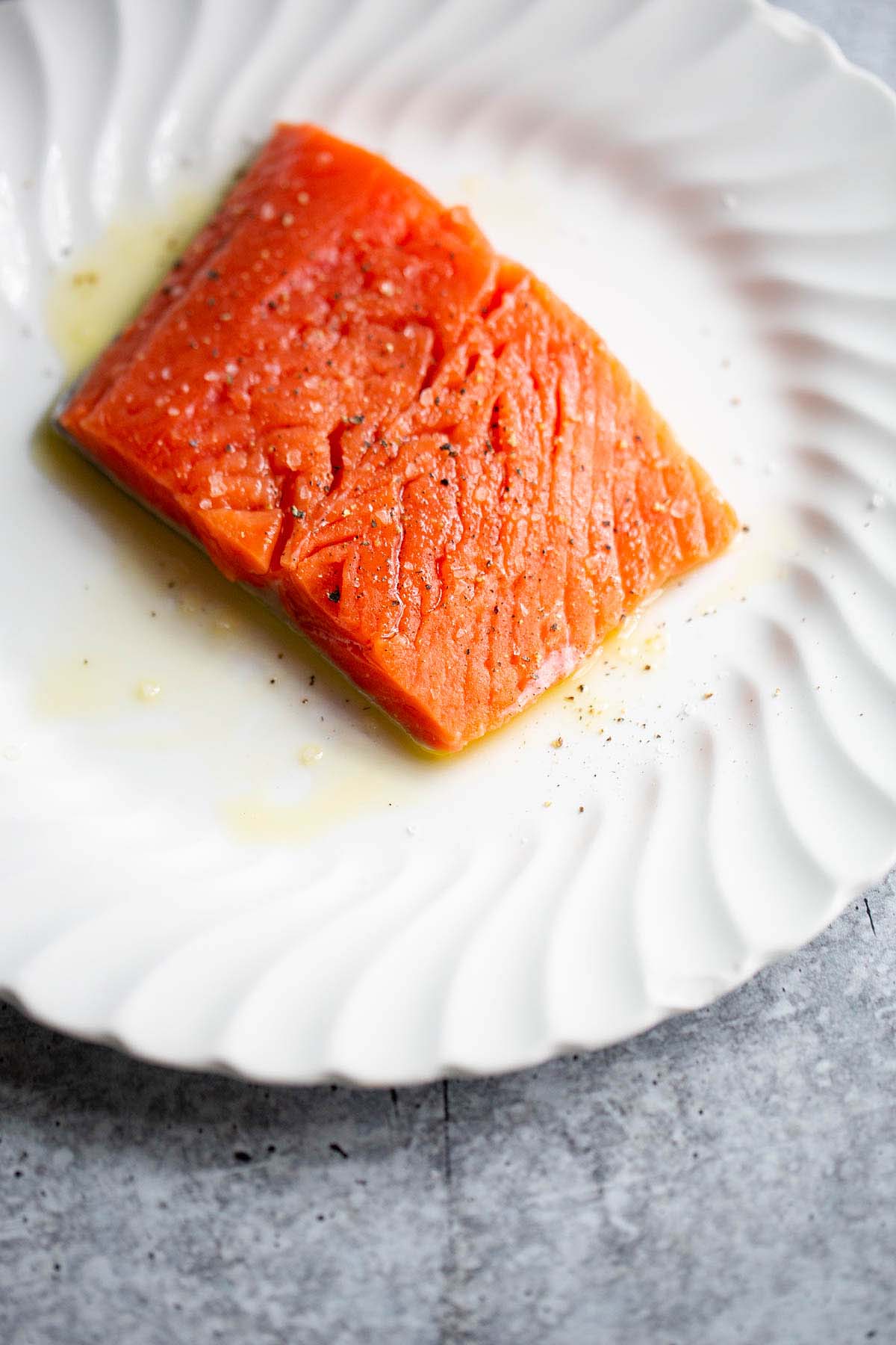 Raw salmon on a white plate.