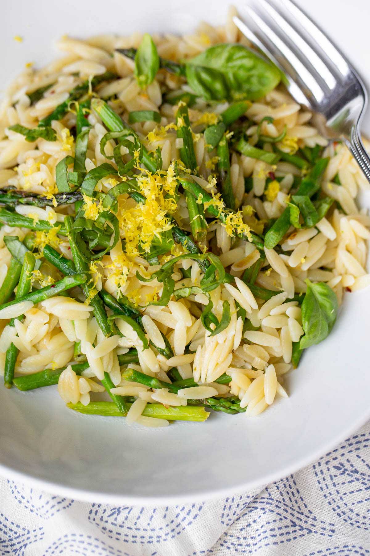 Asparagus and orzo in a bowl up close.