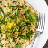 Asparagus and orzo in a bowl up close.