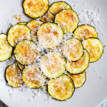 harissa zucchini chips with parmesan on top.