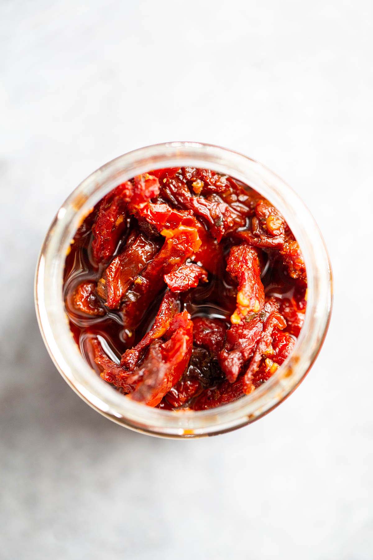 Sundried tomatoes in a jar from above.