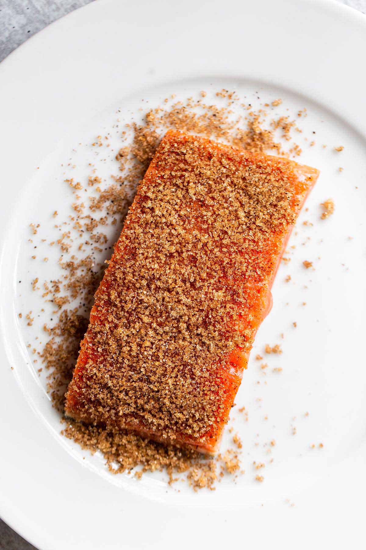 Raw salmon with brown sugar sprinkled on top.