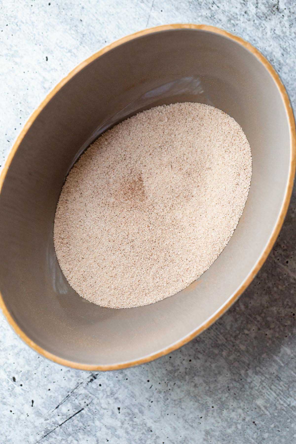 Cinnamon and sugar mixed together in a bowl.