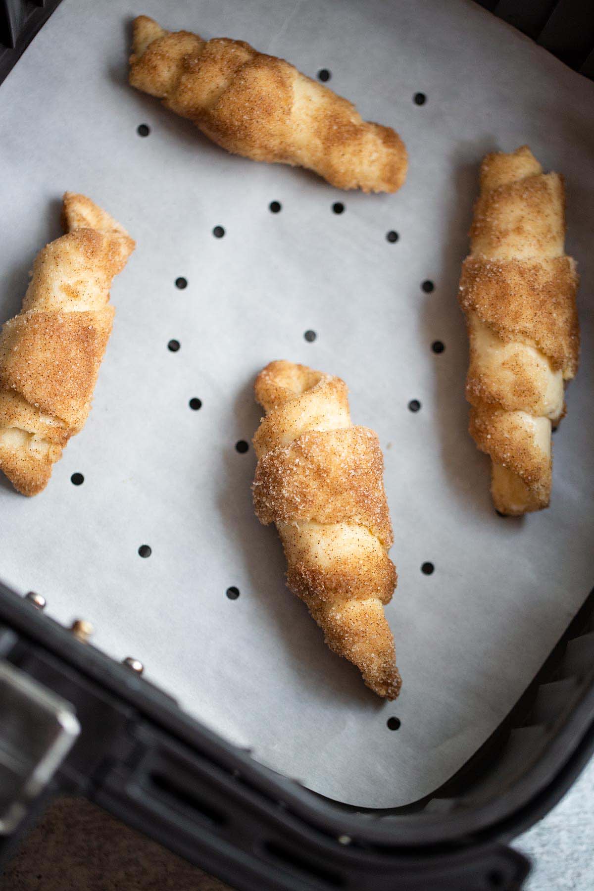 Uncooked croissants in the air fryer.